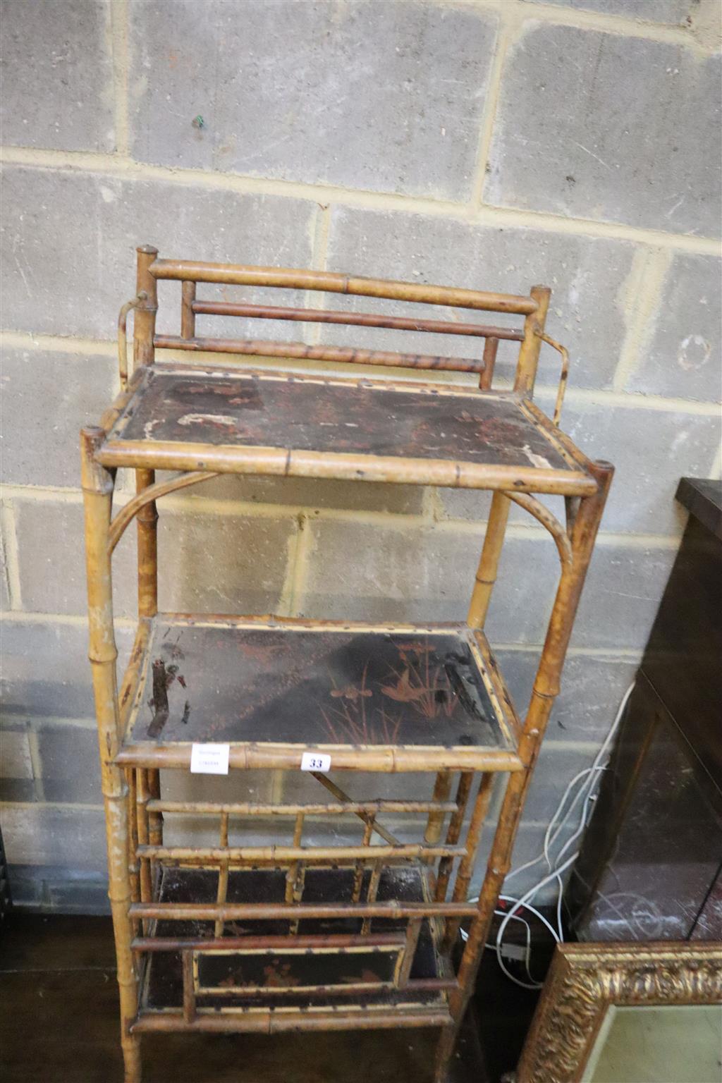 A late Victorian lacquered three tier bamboo Canterbury whatnot, width 50cm, depth 31cm, height 120cm